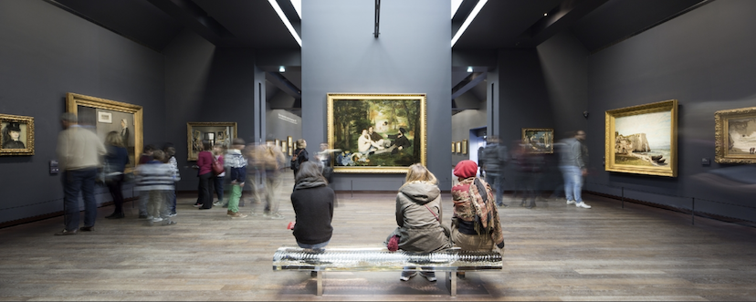 Musee D'Orsay visitors look at the painting "Dejeuner sur l'herbe" by Eduard Manet. 